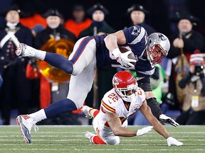 Kansas City Chiefs cornerback Marcus Peters (22) tackles New England Patriots tight end Rob Gronkowski (87) during the fourth quarter in the AFC Divisional round playoff game at Gillette Stadium. Greg M. Cooper-USA TODAY Sports
