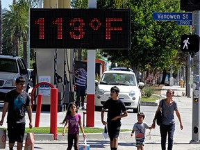 In this Aug. 15, 2015 file photo, pedestrians walk past a digital thermometer reading 113 degrees Fahrenheit in the Canoga Park section of Los Angeles. Earth last year wasn’t just the hottest year on record, but it left a century of temperature high marks in its hot dust. The National Oceanic Atmospheric Administration (NOAA) and NASA announced Wednesday, Jan. 20, 2016, that 2015 was by far the hottest year in 136 years of record keeping. (AP Photo/Richard Vogel, File)