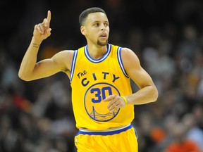 Golden State Warriors guard Stephen Curry celebrates a three-point basket against the Cleveland Cavaliers at Quicken Loans Arena. (David Richard/USA TODAY Sports)