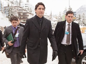 Prime Minister Justin Trudeau, accompanied by staff members, walks through town as he heads to a bilateral meeting in Davos, Switzerland on Wednesday, Jan. 20, 2016. Trudeau is attending the the World Economic Forum where political, business and social leaders gather to discuss world agendas. (THE CANADIAN PRESS/Andrew Vaughan)