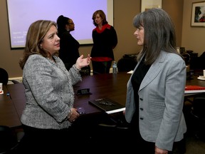 Cristina Martins, left, the parliamentary assistant to the Minister of Citizenship, Immigration and International Trade, speaks with Sophie Kiwala, MPP for Kingston and the Islands, after a meeting at the Greater Kingston Chamber of Commerce on Wednesday. (Ian MacAlpine/The Whig-Standard)