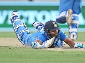 Indian’s Rohit Sharma dives into his crease as the ball bounces in front of him during their One Day International cricket match against Australia in Canberra. (AP)
