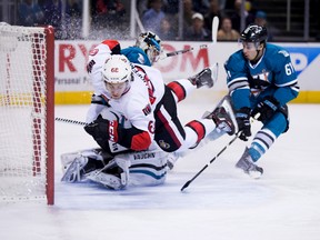 Ottawa Senators winger Mike Hoffman (68) collides into the goal post as San Jose Sharks goalie Alex Stalock (32) makes the save in front of defenceman Justin Braun at SAP Center at San Jose. (Kelley L Cox/USA TODAY Sports)
