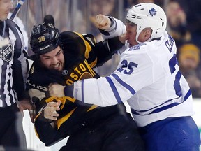 Rich Clune of the Maple Leafs (right) tussles with Zac Rinaldo of the Boston Bruins on Jan. 16, 2016, during a rare fight involving a Leafs player this season. (MICHAEL DWYER/AP)