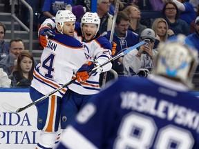 Zack Kassian (44) celebrates his goal with Iiro Pakarinen, right, during the first period of Tuesday’s game against the Lightning in Tampa, Florida. The Oilers lost the game 6-4. (AP photo)