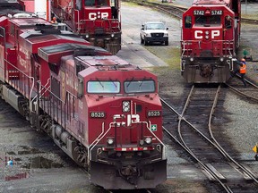 A Canadian Pacific Railway maintenance worker climbs onto a locomotive at the company's Port Coquitlam yard east of Vancouver, B.C., on Wednesday May 23, 2012. THE CANADIAN PRESS/Darryl Dyck
