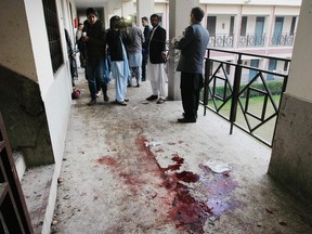 Reporters stand in a corridor at the Bacha Khan University in Charsadda town, some 35 kilometers (21 miles) outside the city of Peshawar, Pakistan, Wednesday, Jan. 20, 2016. Gunmen stormed Bacha Khan University named after the founder of an anti-Taliban political party in the country's northwest Wednesday, killing many people, officials said. (AP Photo/Mohammad Sajjad)