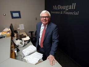 LUKE HENDRY/The Intelligencer
Chief executive officer Ross McDougall stands behind the front desk of his company's headquarters in Belleville. The firm has merged with Kingston-based Upper Canada Commercial Insurance Group Inc.