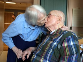 Walter and Leslie Kimmel, who are both 100 years old, enjoy a kiss as they celebrate their 75th wedding anniversary Tuesday, Aug. 18, 2015, at Charlestown Retirement Community in Catonsville, Md. The Kimmels met at Emmanuel Lutheran Church in Baltimore when they were 22 years old. Leslie played the organ and Walter sang in the choir.  (Paul J. Gessler/WBFF-TV via AP)