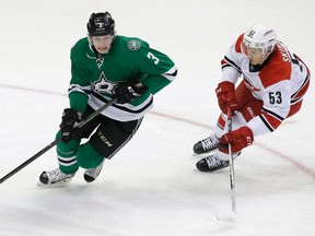 John Klingberg, shown here skating against Hurricanes forward Jeff Skinner during a game in December, grew another four inches after his draft year. (AP photo)