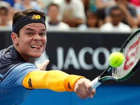Milos Raonic hits a shot during his second-round match against Tommy Robredo at the Australian Open in Melbourne January 21, 2016. (REUTERS/Issei Kato)