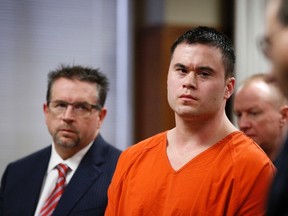 Former Oklahoma City police officer Daniel Holtzclaw (C), stands with his defence attorney Scott Adams (L), as his sentence is read during  hearing in Oklahoma City, Oklahoma, January 21, 2016. Holtzclaw who was convicted of raping four women and sexually assaulting several others while he was on duty, was sentenced Thursday to 263 years in prison, the maximum allowable. REUTERS/Sue Ogrocki/Pool