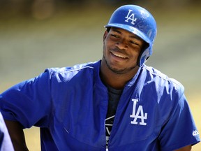 Los Angeles Dodgers right fielder Yasiel Puig laughs during workouts before Game 1 of the NLDS at Dodger Stadium. (Gary A. Vasquez/USA TODAY Sports)