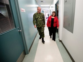 Edmonton Garrison Base Commander Colonel Stephen Lacroix tours the Edmonton Garrison Military Family Resource Centre with Veteran Family Coordinator Denise Kantor, following a press conference to officially announce the launch of the Veteran Family Program, in Edmonton Alta. Thursday Jan. 21, 2016. The four-year pilot project provides medically-released veterans and their families with support for two years after leaving the Canadian Forces. Photo by David Bloom