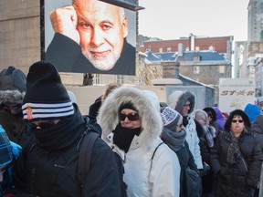 People line up at the visitation for Rene Angelil, husband of singer Celine Dion, at Notre-Dame Basilica Thursday, January 21, 2016 in Montreal. Angelil passed away at the age of 73 after a lengthy battle with throat cancer. (THE CANADIAN PRESS/Paul Chiasson)