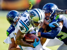 Carolina Panthers wide receiver Ted Ginn (19) is tackled by Seattle Seahawks safety Earl Thomas (29) during the NFC Divisional playoff game at Bank of America Stadium. (John David Mercer/USA TODAY Sports)