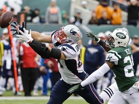 New England Patriots tight end Rob Gronkowski, left, reaches for the ball as New York Jets cornerback Darrelle Revis defends Sunday, Dec. 27, 2015, in East Rutherford, N.J. (AP Photo/Seth Wenig)