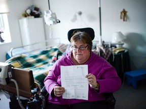 Para Transpo user Janet Timpson pose for a photo at her apartment on Thursday, Jan. 21, 2016.  (James Park / Ottawa Citizen)