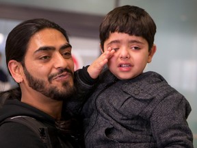 Aman Sood with his son Daksh Sood after being reunited at the Ottawa airport Thursday January 21, 2016. (Errol McGihon/Ottawa Sun)