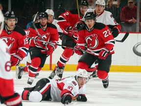 Shane Prince of the Ottawa Senators and Jordin Tootoo of the New Jersey Devils pursue the puck during the first period at the Prudential Center in Newark, N.J., on Jan. 21, 2016. (Photo by Bruce Bennett/Getty Images)