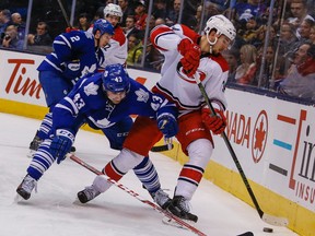 Toronto Maple Leafs' Nazem Kadri tries to take the puck from Carolina Hurricanes' Phillip Di Giuseppe at the Air Canada Centre in Toronto on Jan. 21, 2016. (Dave Thomas/Toronto Sun/Postmedia Network)