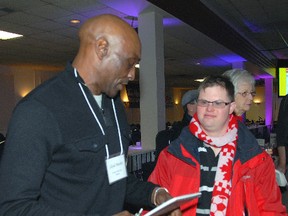 Toronto Blue Jays legend Lloyd Moseby, left, signs an autograph for Corey Cummings, 31, Thursday afternoon at the St. Thomas Sports Spectacular. The annual celebrity meet and greet at the St. Anne's Centre raises money for the Special Olympics and Community Living Elgin.