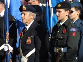 Beth Scott, a member of the Point Edward Ex-Servicemen's Association in Point Edward, and cadet Tairen Snauwaert were part of the colour guard in November at the cenotaph in Point Edward for the village's Remembrance Day service. The ex-servicemen's club is celebrating its 90th anniversary Feb. 6. File photo/Sarnia Observer/Postmedia Network