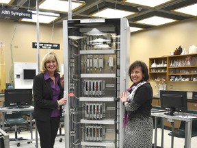 Lambton College president Judy Morris, left, and Nathalie Pilon, CEO of ABB in Canada, are shown with computer equipment the company donated to the college for use by students in its technology programs.
 Handout/Sarnia Observer/Postmedia Network