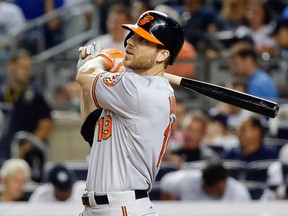 In this Sept. 8, 2015, file photo, Baltimore Orioles' Chris Davis hits a home run during the ninth inning of a baseball game against the New York Yankees in New York. The Orioles have withdrawn their multi-million dollar offer to free agent first baseman Chris Davis,  executive vice president Dan Duquette said Saturday, Dec. 12, 2015. (AP Photo/Frank Franklin II, File)