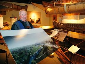 Canadian Canoe Museum executive director Richard Tucker with a display of the chosen new museum of the partnership of Irish firm Heneghan Peng of Dublin and Kearns Mancini of Toronto that were chosen from among five finalists on Thursday, January 21, 2016 at the Canadian Canoe Museum in Peterborough, Ont. Clifford Skarstedt/Postmedia Network