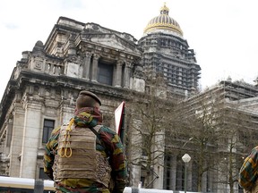 Belgian soldiers stand guard in front of the Brussels' Palace of Justice, January 22, 2016. Belgium has arrested two more men suspected of links to the Paris attacks on Nov. 13 in which 130 people were killed, the Belgian federal prosecutor's office said on Thursday.   REUTERS/Francois Lenoir