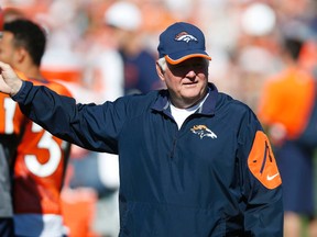 Denver Broncos defensive coordinator Wade Phillips directs players to drills during the morning session at the team's NFL football training camp Wednesday, Aug. 12, 2015, in Englewood, Colo. (AP Photo/David Zalubowski)