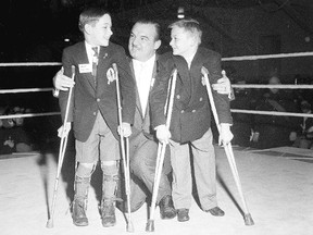 The wrestler Whipper Billy Watson greets children at the first London Sports Celebrity Dinner on March 7, 1957. In those days, the event aided Easter Seals. (Western Archives/London Free Press negative collection)
