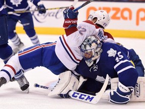 Montreal Canadiens’ Dale Weise (22) falls into Toronto Maple Leafs goalie Jonathan Bernier during NHL action in Toronto on Wednesday, Oct. 7, 2015. (THE CANADIAN PRESS/Frank Gunn)