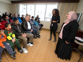 Cross Cultural Learner Centre housing coordinators Perihan El Shamy and Jerusalem Berhane speak to a group of recently arrived Syrian nationals at an information session at the Marriott Residence Inn in London, Ont. on Tuesday January 19, 2016. (Free Press file photo)