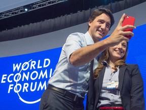 Prime Minister Justin Trudeau poses for a photo with Youmna Naufal from Lebanon after a session on gender parity in Davos, Switzerland on Friday, Jan. 22, 2016.  THE CANADIAN PRESS/Andrew Vaughan