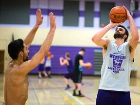 Greg Morrow shoots over Western Mustangs teammate Tony Spiridis during a recent men?s basketball practice at Thames Hall. (MIKE HENSEN, The London Free Press)