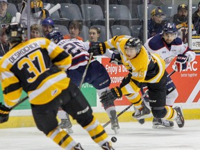 Kingston Frontenacs forward Jason Robertson collides with Saginaw Spirit Kirill Maksimov as they go after the puck during the first period of their Ontario Hockey League game at the Rogers K-Rock Centre in Kingston, Ont., on Friday, January 22, 2016. JULIA MCKAY/The Whig-Standard/Postmedia Network