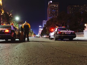 Metro Police officers block Las Vegas Boulevard South at Flamingo Road at the scene of an officer-involved shooting on Friday, Jan. 22, 2016 in Las Vegas. (Mikayla Whitmore /Las Vegas Sun via AP)