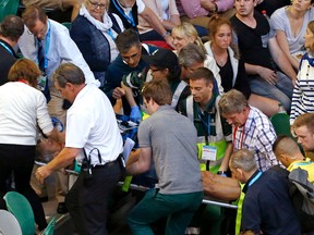 Nigel Sears, coach of Ana Ivanovic, is carried on a stretcher from Rod Laver Arena following a medical emergency during Ivanovic’s third-round match against Madison Keys at the Australian Open in Melbourne Saturday, Jan. 23, 2016. (AP Photo/Rafiq Maqbool)
