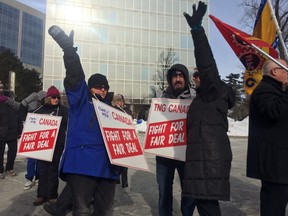 Newsroom employees at Canada's largest independent daily newspaper held signs and waved to honking cars on the first day of a strike Saturday, Jan. 23, 2016. The Halifax Chronicle Herald workers walked off the job at 12:01 a.m. Saturday after talks broke down earlier this week. THE CANADIAN PRESS/Aly Thomson
