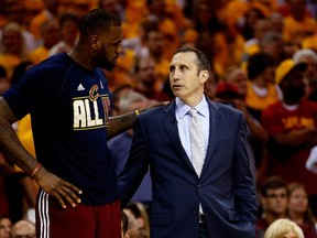 LeBron James of the Cleveland Cavaliers and head coach David Blatt speak during a playoff game against the Atlanta Hawks at Quicken Loans Arena on May 26, 2015 in Cleveland. (Gregory Shamus/Getty Images/AFP)