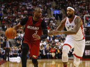 Miami Heat Dwyane Wade tries to stay away from Toronto Raptors James Johnson in the fourth quarter in Toronto, Ont. on Friday January 22, 2016. (Jack Boland/Toronto Sun/Postmedia Network)
