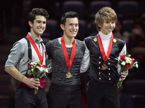 Senior men's silver medallist Liam Firus, from left to right,  gold medallist Patrick Chan, and bronze medallist Kevin Reynolds pose for photos during the Canadian Figure Skating Championships in Halifax on Saturday, January 23, 2016. (THE CANADIAN PRESS/Darren Calabrese)