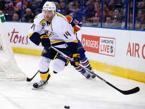 Predators' forward Mattias Ekholm is chase behind the Oilers net during first-period action Saturday at Rexall Place. (David Bloom)