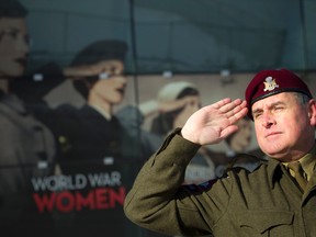 Terry Hunter salutes outside the Canadian War Museum. Hunter, a veteran and history buff, noticed a museum poster of Second World War-era women using a wrong "American-style" salute. Ashley Fraser / Postmedia Network