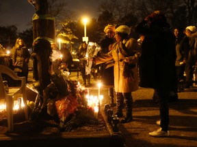 Mourners attended a vigil Sunday night for murder victim Alva Dixon. (JACK BOLAND, Toronto Sun)