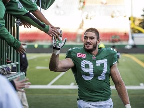 Saskatchewan Roughriders defensive end John Chick (97) celebrates with fans after their CFL football game against the Montreal Alouettes in Regina, Saskatchewan September 27, 2015.  The Saskatchewan Roughriders defeated the Montreal Alouettes 33-21. REUTERS/Matt Smith