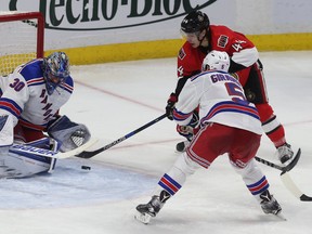 Rangers goalie Henrik Lundqvist makes a save against Senators Jean-Gabriel Pageau during third period action Sunday. The Ottawa Senators defeated the New York Rangers 3-0.   Tony Caldwell/Postmedia Network