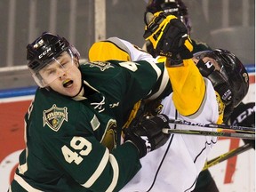Max Jones of the London Knights exchanges blows with Alex Black of the Sarnia Sting during the second period of London?s 4-1 win Sunday at Budweiser Gardens. Sarnia coach Derian Hatcher blamed Jones for sparking a brawl late in the third period. (DEREK RUTTAN, The London Free Press)